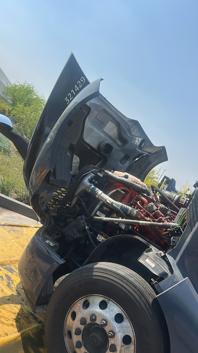 Volvo semi-truck hood up showing engine bay detail